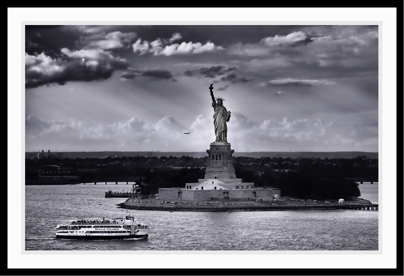 Statue of Liberty with dramatic sky.